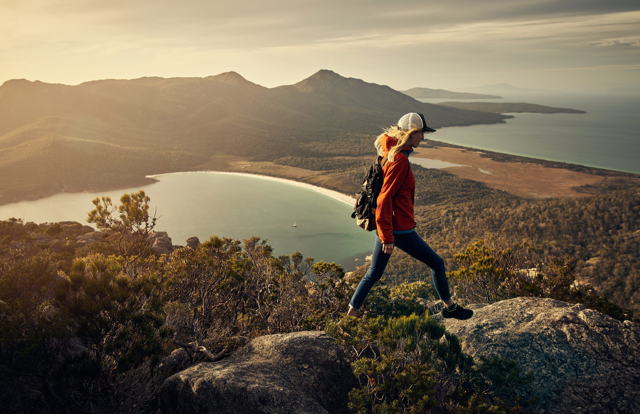 Full length shot of a young woman hiking through the mountains